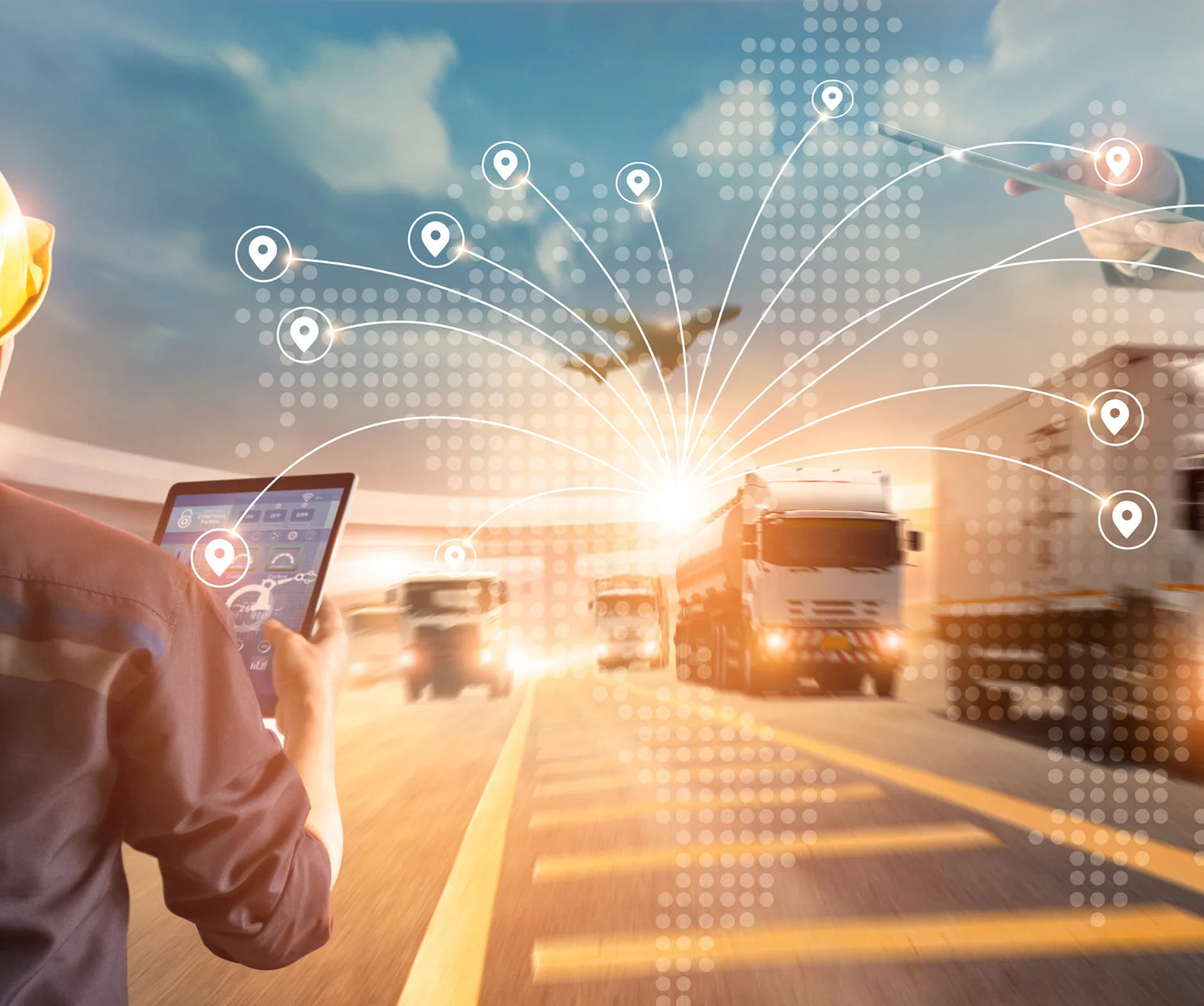 GettyImages-518979473 1 (1) Person with tablet monitoring logistics, showing trucks and a plane with digital tracking icons, representing global transportation network.